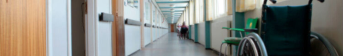 wheelchair in empty care facility hallway